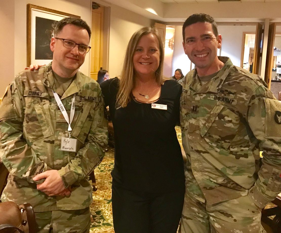 On Springer's left is Eric Strom, a Licensed Clinical Social Worker who is a Behavioral Health Officer in the Army National Guard. On her right is psychologist Kyle Curry, also in the Army National Guard.