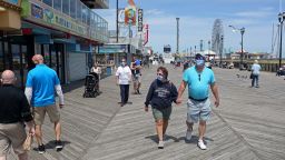 SEASIDE HEIGHTS, NJ - MAY 16: People traverse the Seaside Heights boardwalk as the state begins to reopen beaches and boardwalks amid the novel coronavirus pandemic on May 16, 2020 in Seaside Heights, New Jersey. New Jersey Gov. Phil Murphy said he is willing and ready to bring back social distancing rules if he begins to see a spike in cases in the state. "If we have to pull the brakes we will do that." (Photo by Yana Paskova/Getty Images)