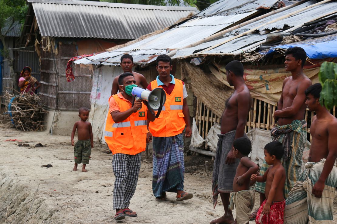 A volunteer urges residents to evacuate to shelters ahead of the expected landfall of the cyclone in Khulna, Bangladesh, on May 19.