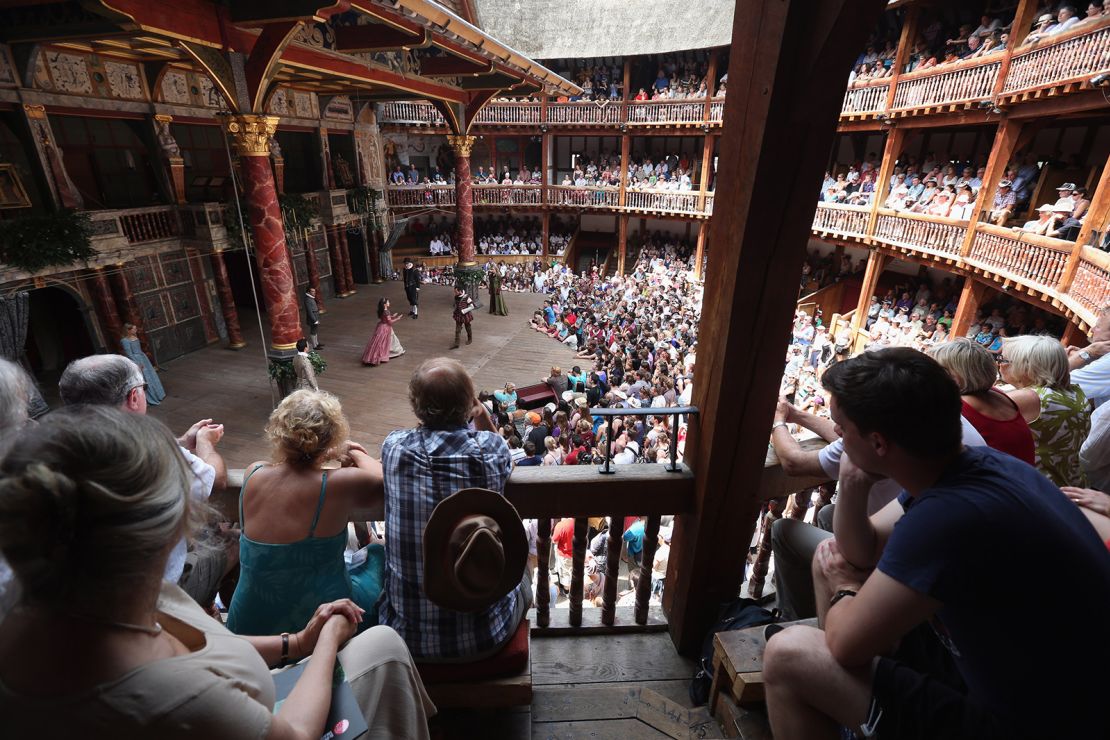 Audience members watch a production of "A Midsummer Night's Dream" in Shakespeare's Globe theatre on the Southbank of the River Thames on July 16, 2013 in London, England. 