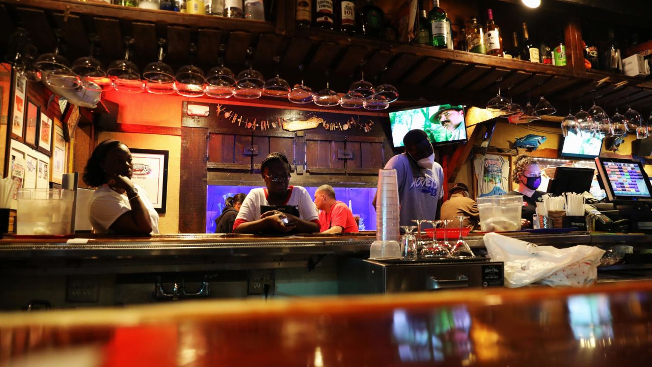 People wait at the bar of a restaurant as the coronavirus disease outbreak continues, in Atlanta, Georgia, U.S., May 15, 2020.