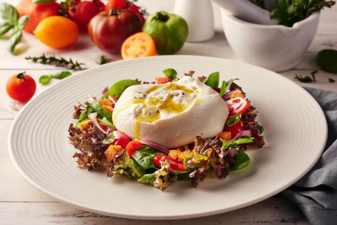 Fresh cow's milk burrata cheese from Ronda Locatelli comes with panzanella salad, cherry tomatoes and red onion.