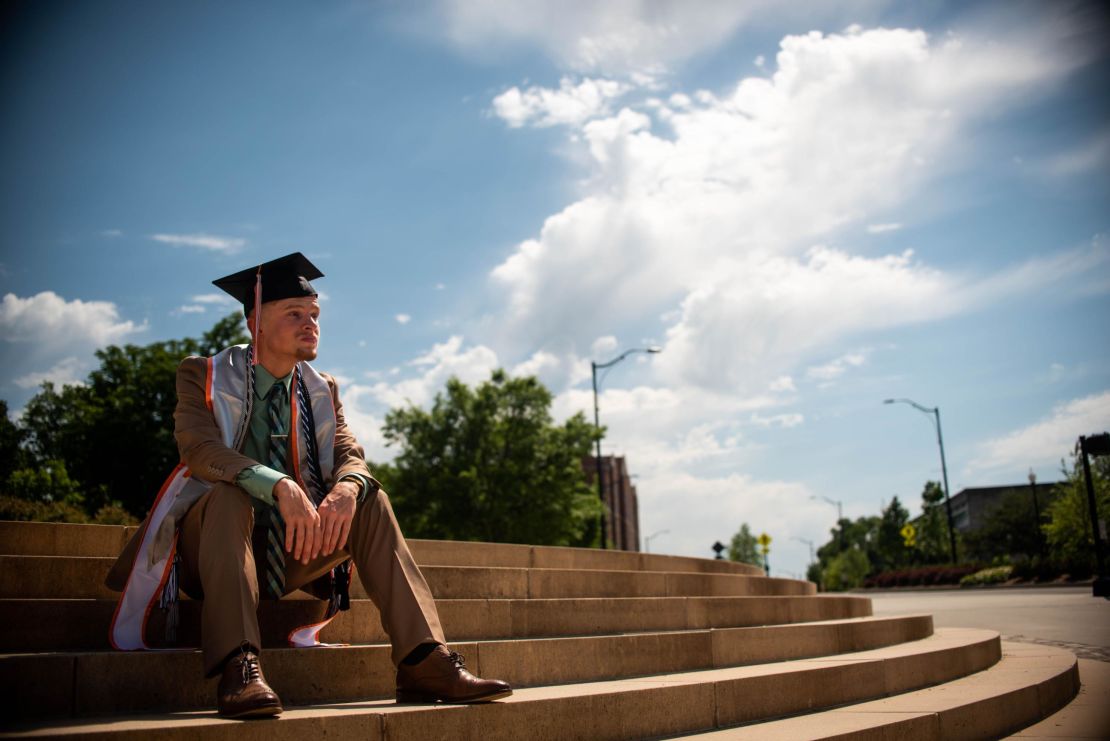 Cory Sanning wears his graduation cap and gown but there was no in-person ceremony for him.                                                     
