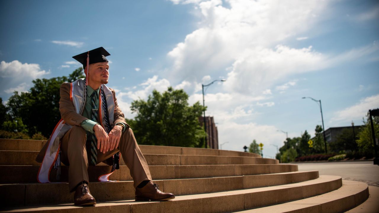 Cory Sanning wears his graduation cap and gown but there was no in-person ceremony for him.                                                     