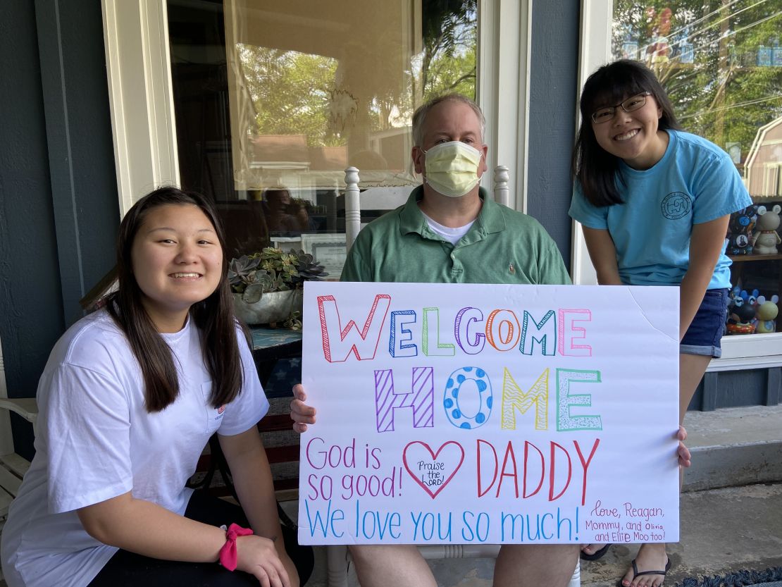 Michael Herbert with his daughters after being in the hospital with Covid-19.