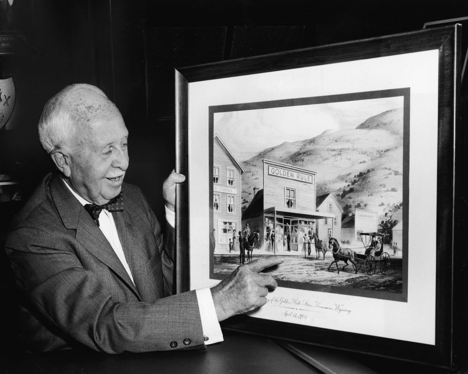 Businessman James Cash Penney points to a picture of his first store in Kemmerer, Wyoming. JCPenney started in 1902 as a dry-goods store called the Golden Rule Store. At the time, Penney's business practices were revolutionary. He banned haggling, a common practice at the time, to keep prices low. And he encouraged his employees to "serve the public to its ultimate satisfaction." The company changed its name a decade later, opened many more stores and went public in 1929.