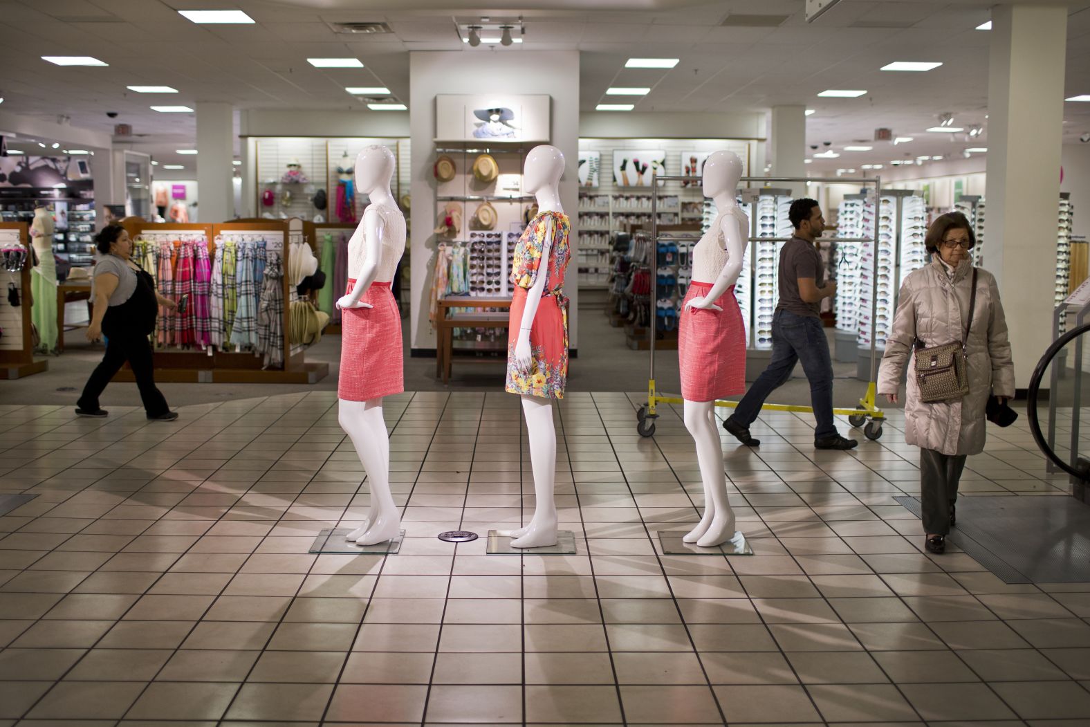 Customers walk past mannequins at a JCPenney store in New York in 2013.