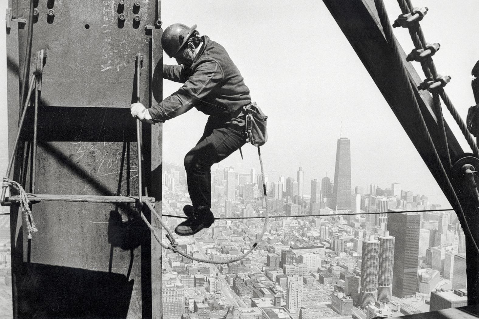 An iron worker helps construct the Sears Tower in Chicago. Sears' new headquarters, built in 1973, was the world's tallest building until 1998. Sears sold the building in 1994.