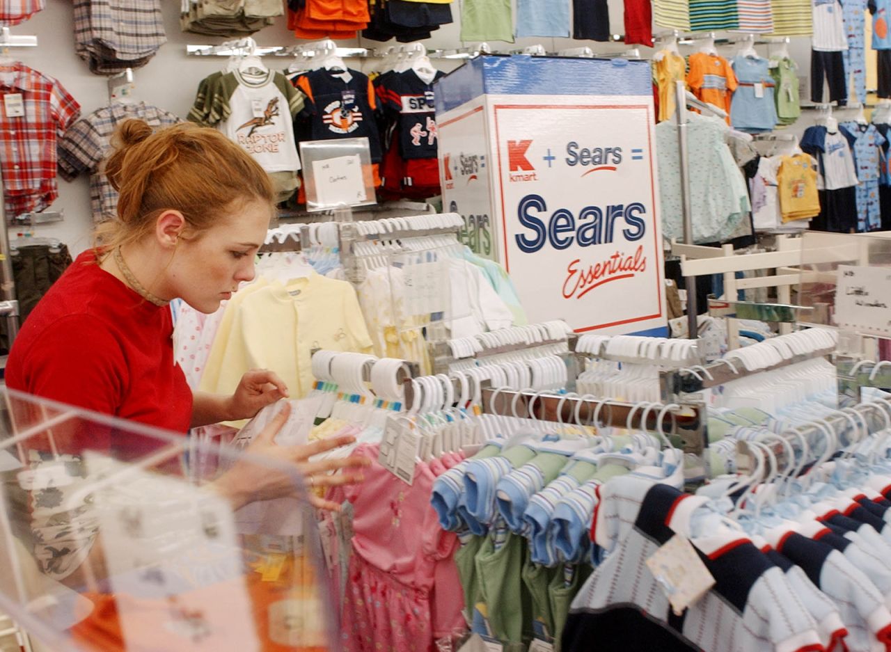 Kaylin Wilson sets up children's clothes in a Kmart in Nashua, New Hampshire, in 2005. The store was the first Kmart in the country to begin receiving Sears merchandise after stockholders voted on a merger to form the nation's third largest retailer.