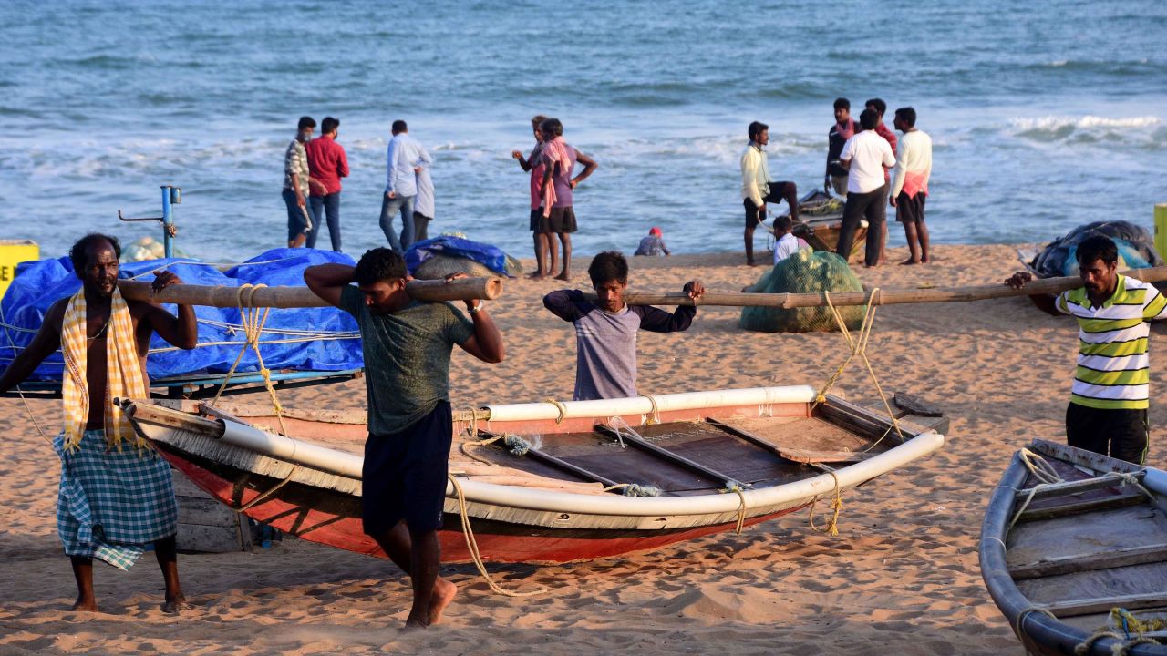 Fishermen bringing in their boats after warnings were sounded ahead of the cyclone's arrival on May 18 in Puri, India.