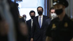 Steven Mnuchin, U.S. Treasury secretary, center, wears a protective mask while arriving at the U.S. Capitol in Washington, D.C., U.S., on Tuesday, May 19, 2020. Lawmakers will receive an update today on implementation of the $2.2 trillion virus rescue package passed by Congress in March. 