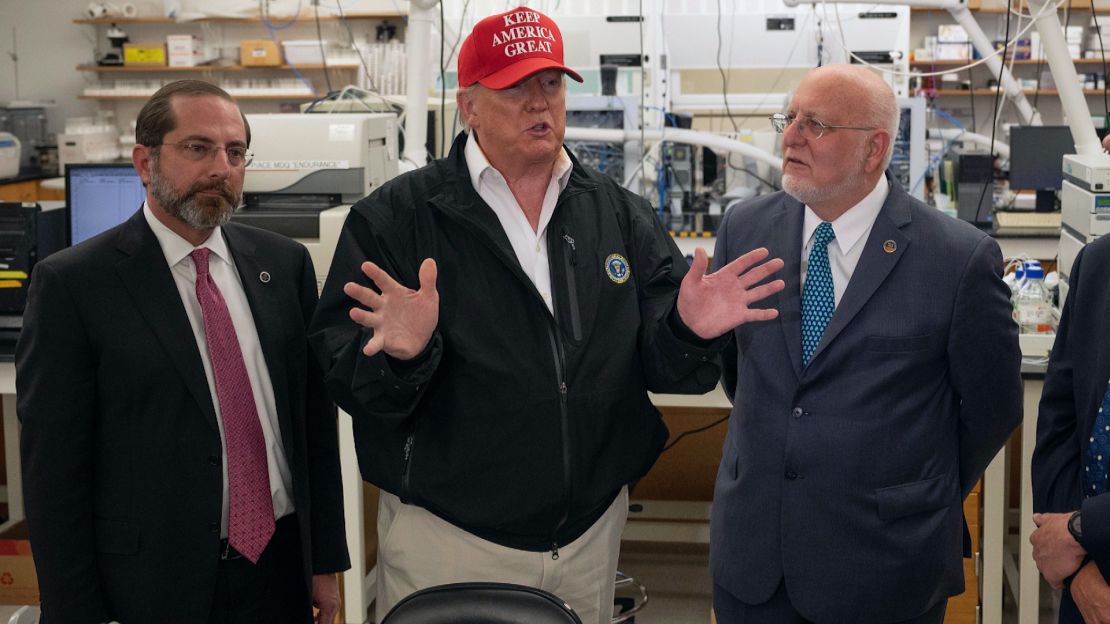 President Donald Trump speaks next to US Health and Human Service Secretary Alex Azar and CDC Director Robert Redfield during a tour of the Centers for Disease Control and Prevention on March 6, 2020.