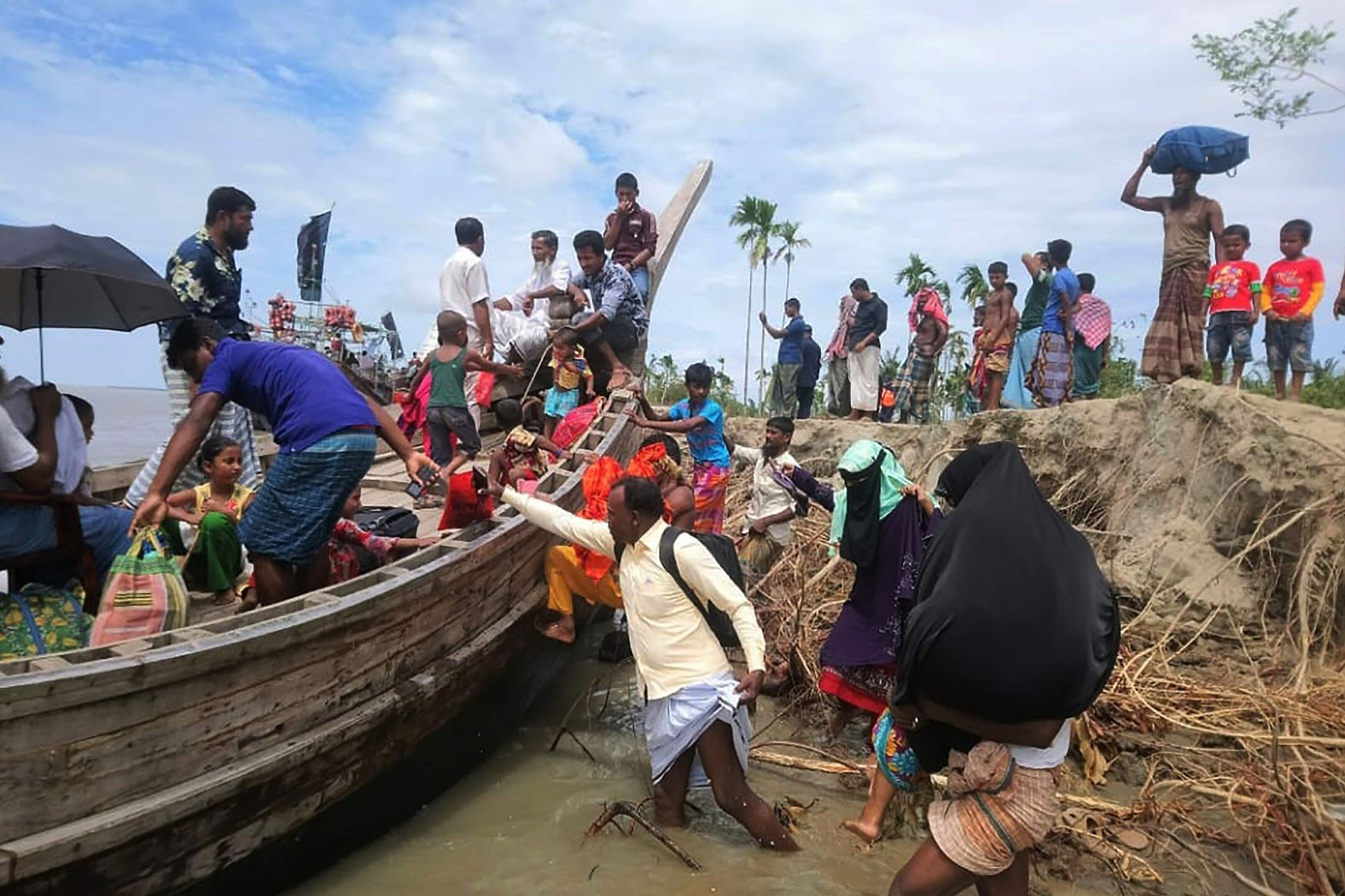 A handout photo from local officials shows residents evacuating the Dhalchar village on the Bangladeshi island of Bhola.
