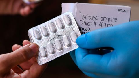 A vendor displaying hydroxychloroquine tablets at a pharmacy.