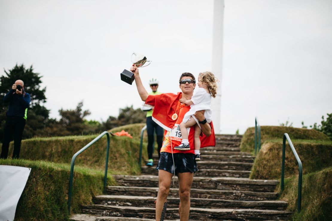Christian Varley celebrates with his daughter after completing his 19th marathon.