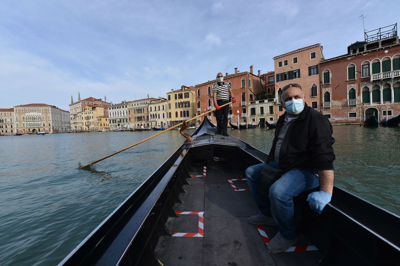 A gondolier transports his first customer as gondola services resume in Venice, Italy, on May 18. <a href="http://www.cnn.com/travel/article/venice-future-covid-19/index.html" target="_blank">Related story: Deserted Venice contemplates a future without tourist horde</a>