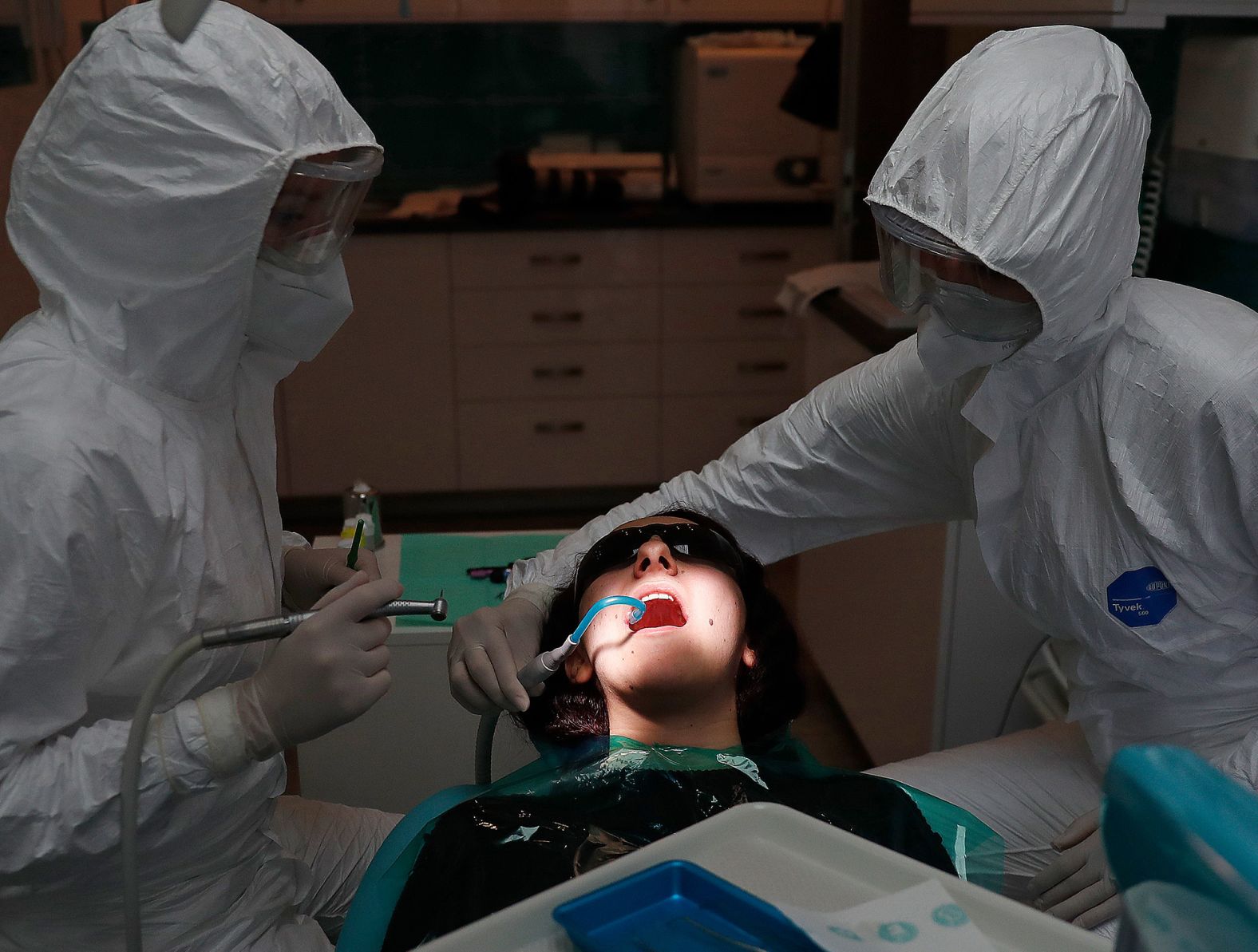 Dentist Dora Gemesi and her assistant, Time Raksi-Csuhai, work on a patient in Budapest, Hungary, on May 18. It was the first day that dental practices reopened in the country.