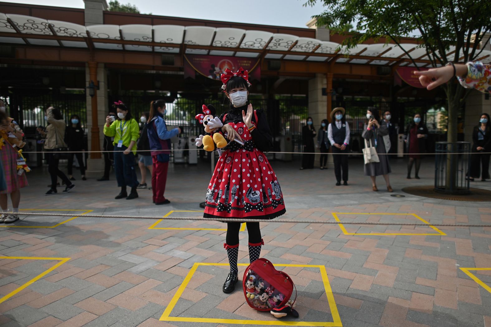 A woman stands on a designated spot to maintain distance while waiting to enter the Disneyland amusement park in Shanghai, China, on May 11. <a href="http://www.cnn.com/travel/article/shanghai-disneyland-reopens-intl-hnk/index.html" target="_blank">The park had been closed</a> for three and a half months. Visitors are now required to wear masks, have their temperatures taken and practice social distancing.