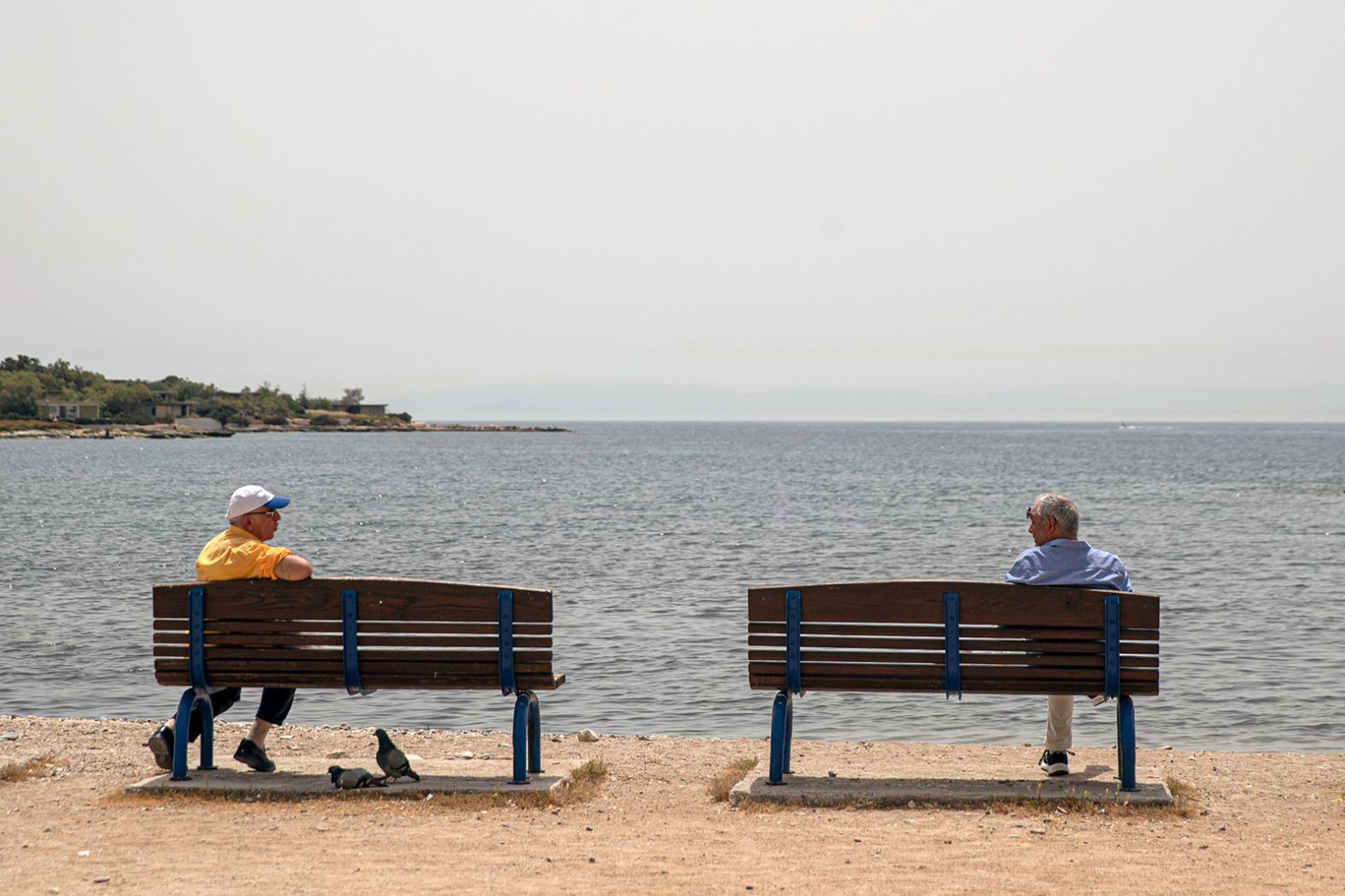 Men maintain their distance from each other while speaking in Glyfada, Greece, on May 15.