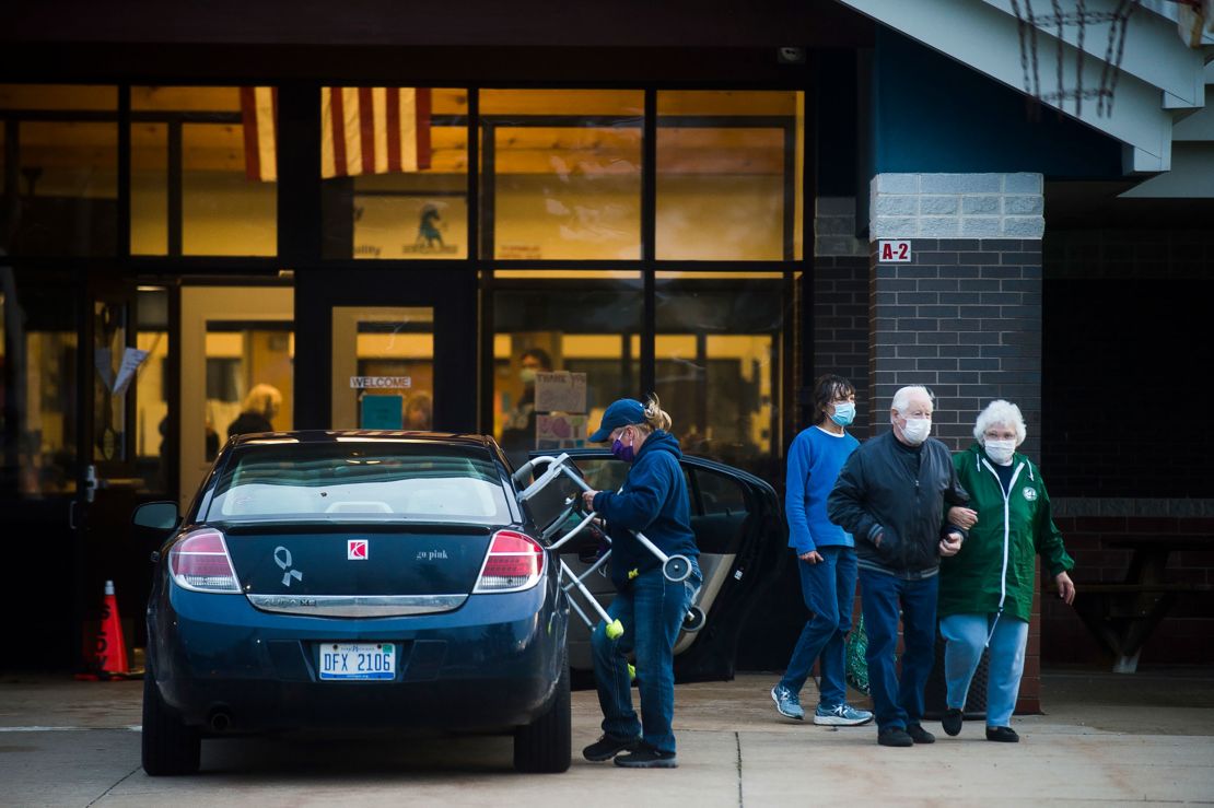 People stand outside a shelter at Meridian Junior High School, in Sanford, Michigan, this week.