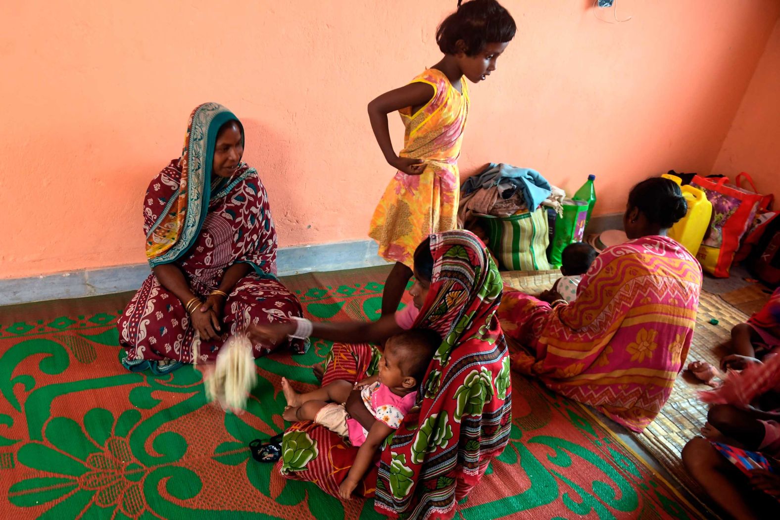 Residents gather at a shelter in Tajpur, India.