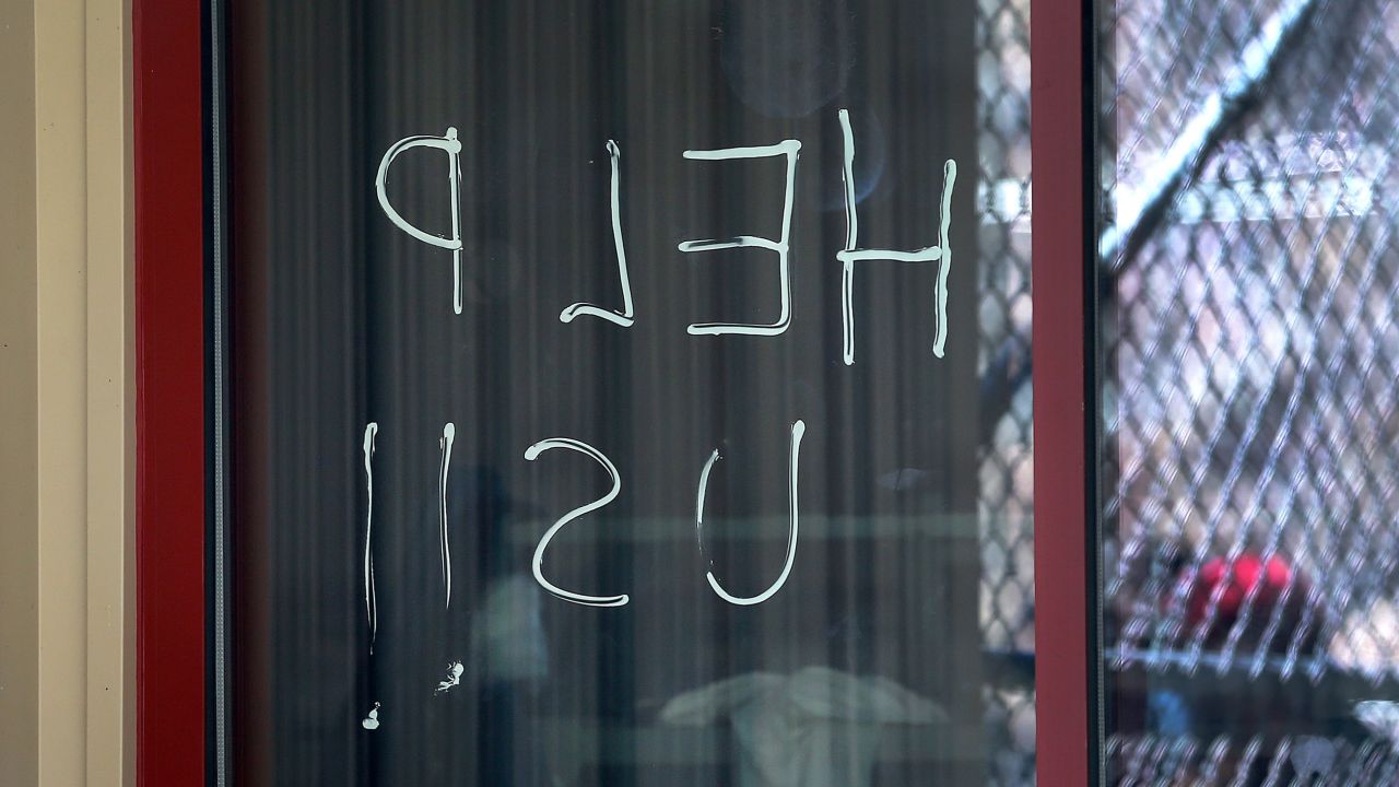 "Help us" is seen written on a window at an ICE facility at the Bristol County Sheriff's correctional complex on May 2, 2020.