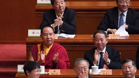 The Chinese government-selected 11th Panchen Lama Gyaincain Norbu (middle row left) applauds during a plenary session of the Chinese People's Political Consultative Conference in Beijing on March 10, 2019.