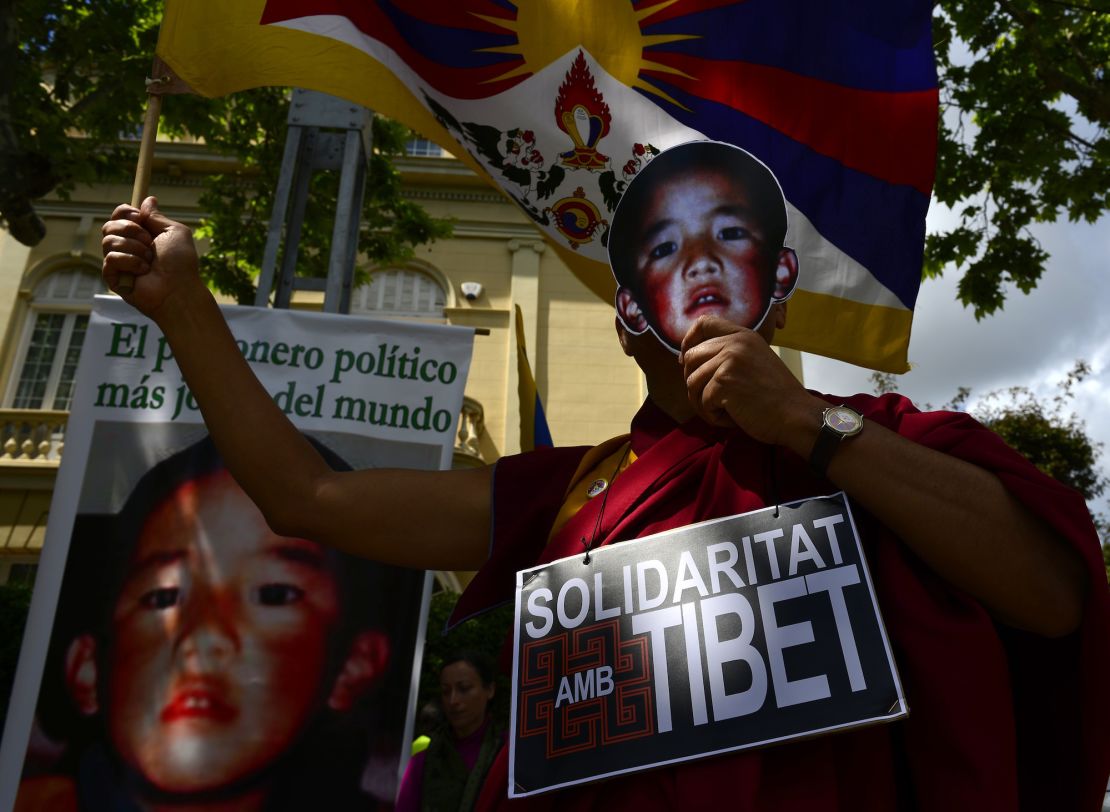 Pro-Tibetan protestors hold picures of Gendun Cheokyi Nyima (recognized by the Dalai Lama as the 11th Panchen Lama) during a demonstration outside the Chinese consulate in Barcelona on May 17, 2013.