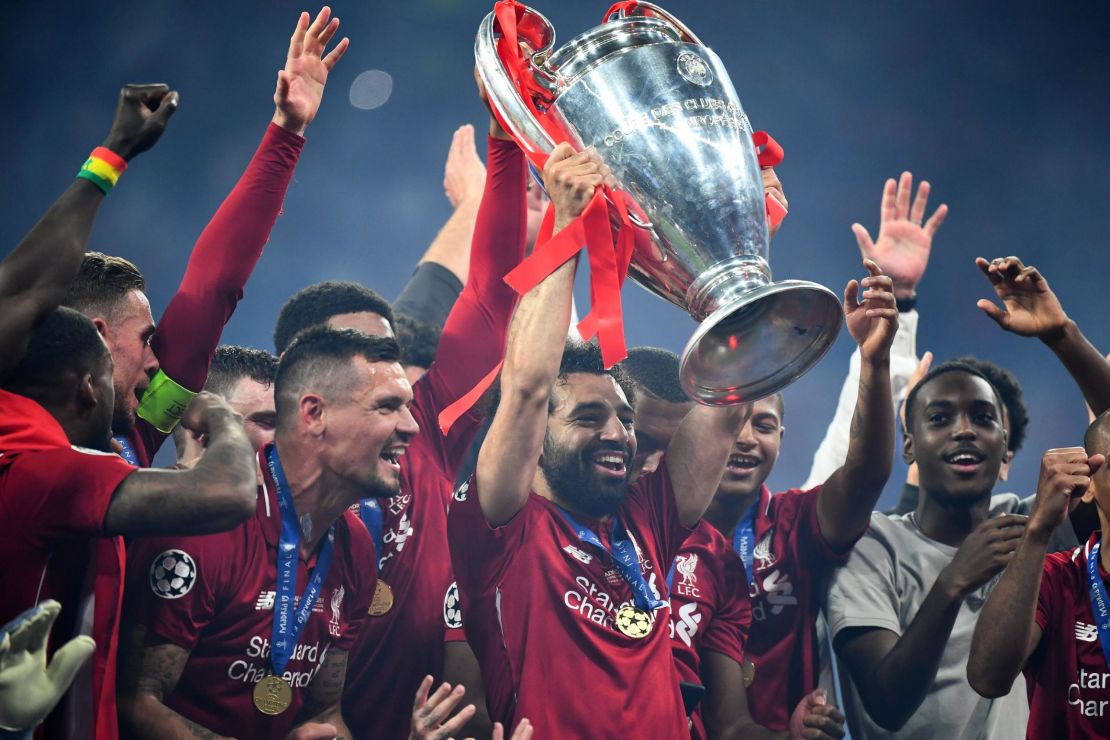 Salah raises the Champions League trophy. 