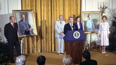 President Jimmy Carter makes remarks at the unveiling of the portraits of former President Gerald R. Ford and former first lady Betty Ford in the East Room of the White House in August 1980. 