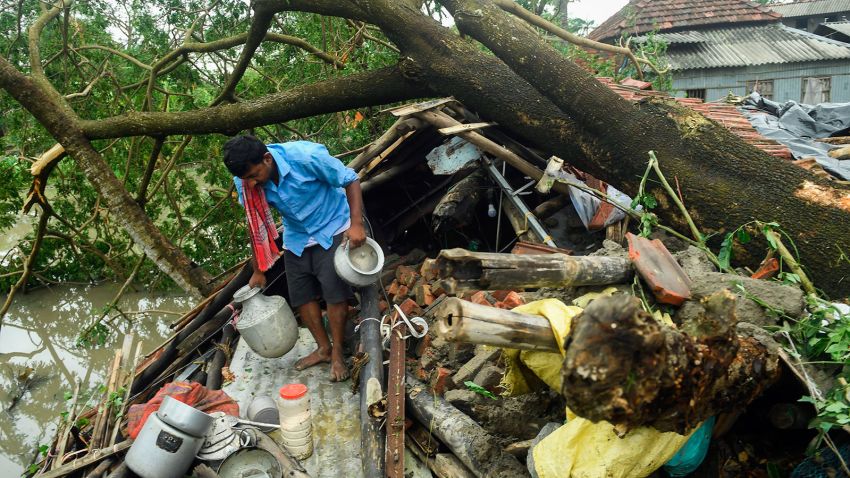 A man salvages items from his house damaged by cyclone Amphan in Midnapore, West Bengal, on May 21, 2020. - The strongest cyclone in decades slammed into Bangladesh and eastern India on May 20, sending water surging inland and leaving a trail of destruction as the death toll rose to at least nine. (Photo by Dibyangshu SARKAR / AFP) (Photo by DIBYANGSHU SARKAR/AFP via Getty Images)
