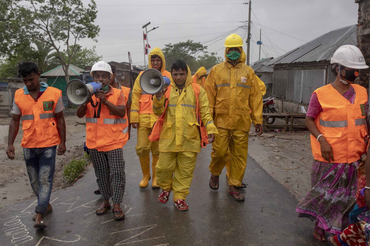Volunteers of the Cyclone Preparedness Program use a megaphone to urge residents to evacuate Dacope, Bangladesh, on May 20.