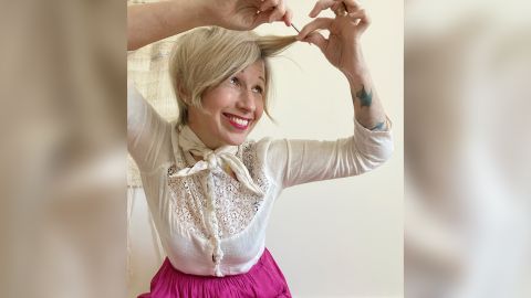 Jayne Matthews, co-owner and creative director of Edo Salon, 47, in Oakland, California demonstrates a hair styling tip for a tutorial to customers.