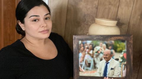 Monica V. Garcia with a photo of her father, Carlos, who died of Covid-19.