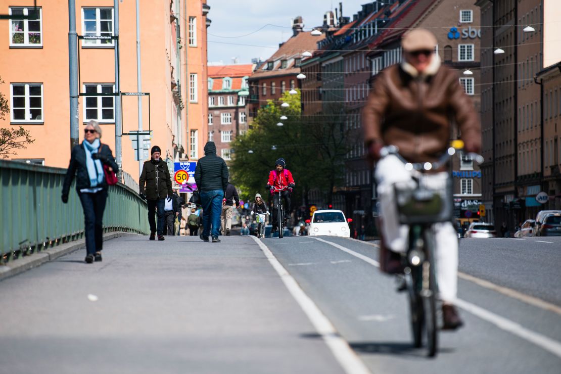 Pedestrians and cyclists cross a bridge in the heart of Stockholm on May 11.