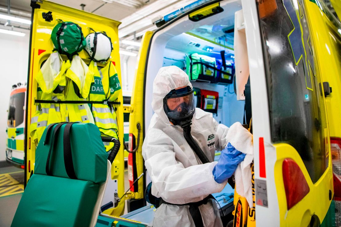 A healthcare worker cleans and disinfects an ambulance after dropping a patient at the Intensive Care Unit (ICU) at Danderyd Hospital near Stockholm on May 13.