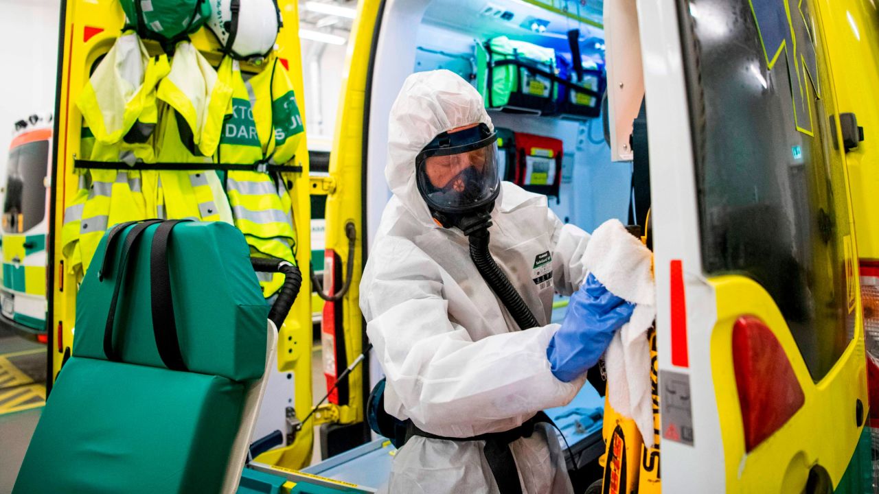 A healthcare worker cleans and disinfects an ambulance after dropping a patient at the Intensive Care Unit (ICU) at Danderyd Hospital near Stockholm on May 13.