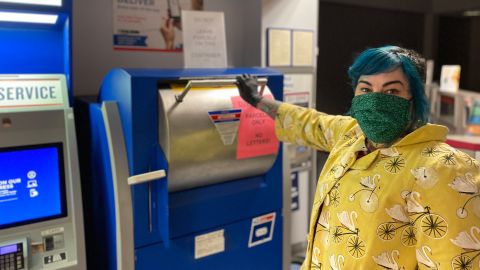 Tina Marabito, owner of Poppycock Tattoo, sells merchandise from her online shop, including art prints and t-shirts.