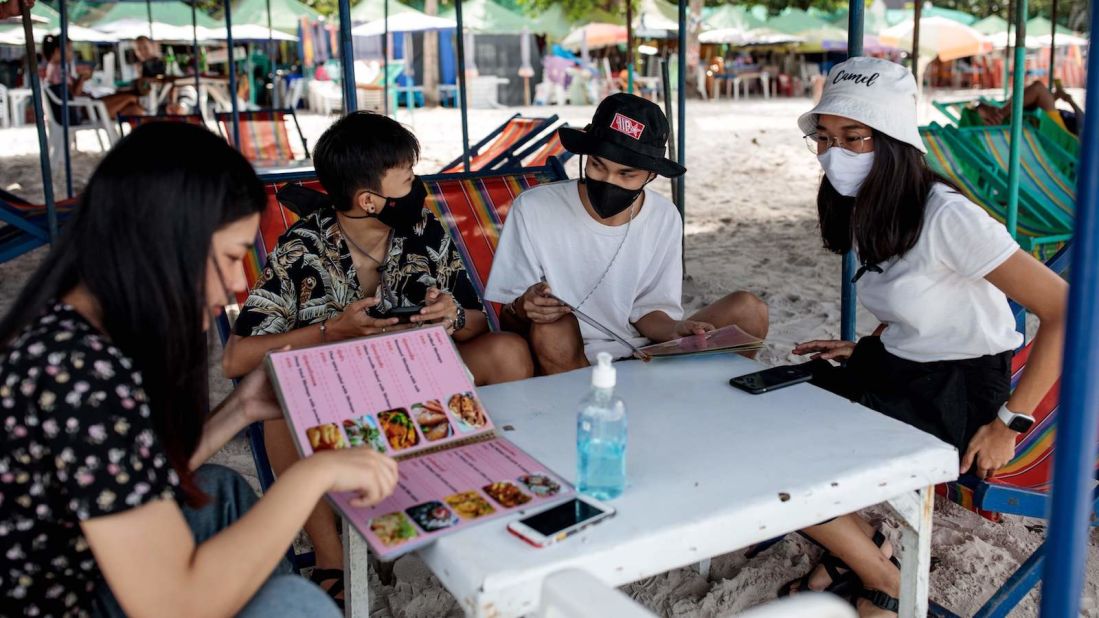 <strong>Domestic tourism: </strong>Visitors order dishes from a food stall at a Hua Hin beach on May 19, 2020. Thailand officials say they're planning for a rise in domestic tourism in June. International tourists, however, won't likely be able to return until the final quarter of this year.  