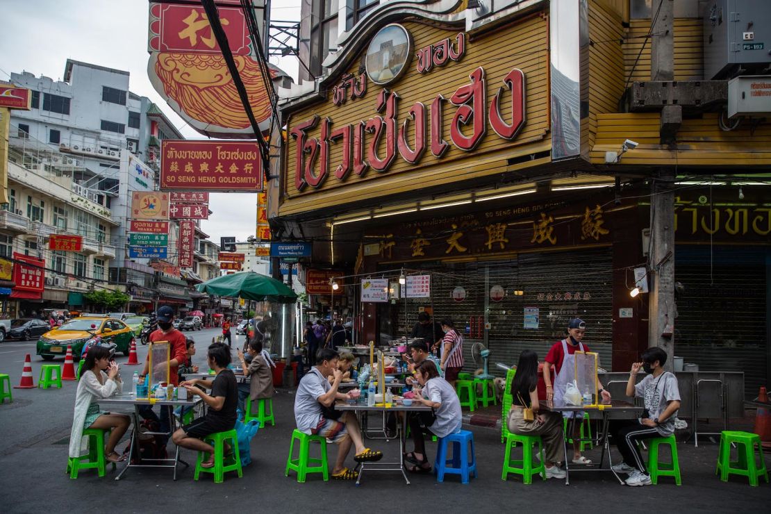 Bangkok's famous street food vendors have reopened, but diners must follow strict social distance rules.