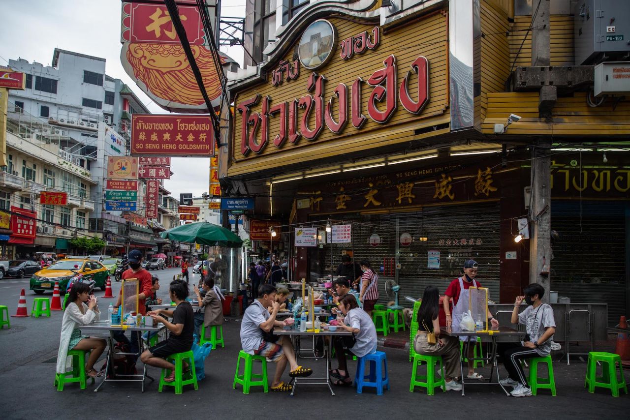 Bangkok's famous street food vendors have reopened, but diners must follow strict social distance rules. 
