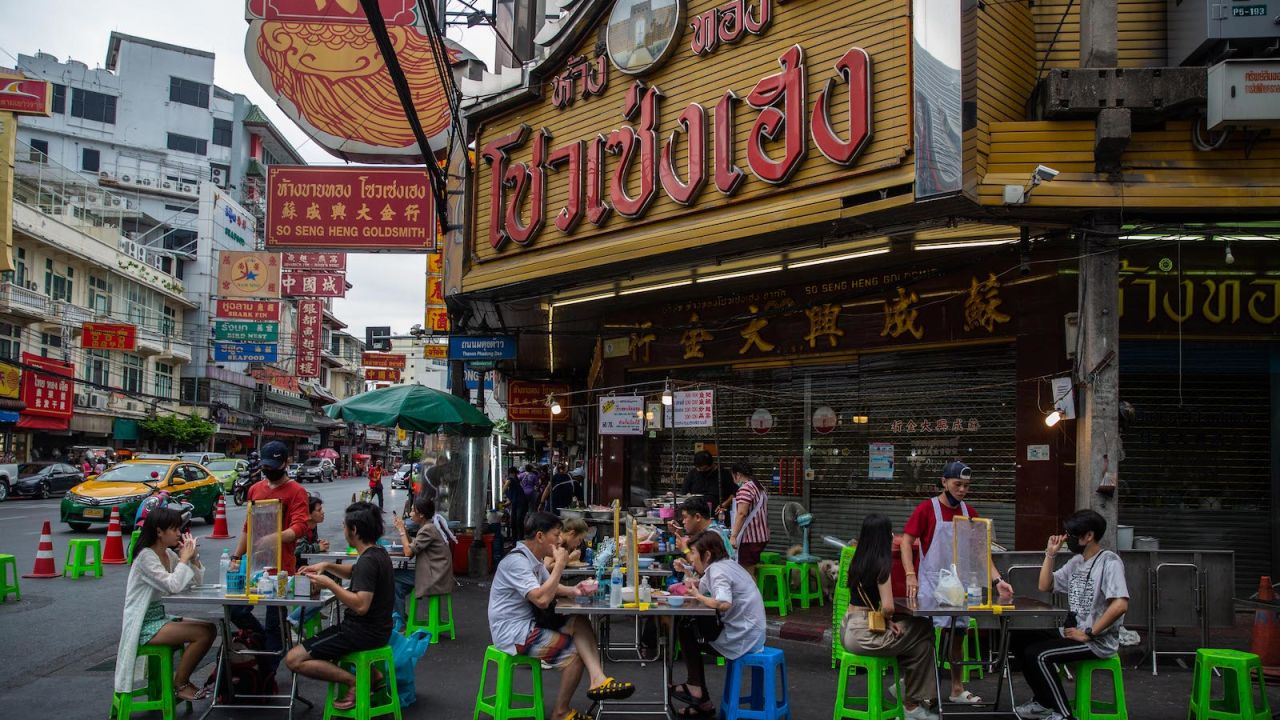Bangkok's famous street food vendors have reopened, but diners must follow strict social distance rules. 