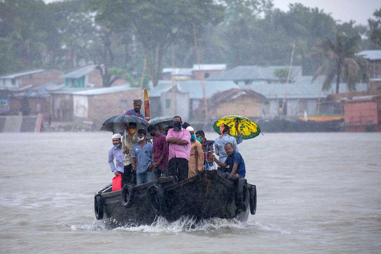 People cross a river in Dacope, Bangladesh, seeking high ground before <a href="https://www.cnn.com/2020/05/20/weather/gallery/cyclone-amphan/index.html" target="_blank">Cyclone Amphan made landfall</a> on Wednesday, May 20. Amphan ripped through Bangladesh and India, tearing apart homes, knocking down trees and leaving some rural areas without power or communications. It was the most powerful cyclone ever recorded in the Bay of Bengal.
