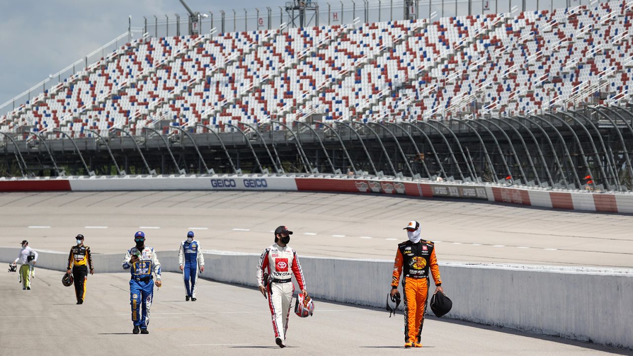 With no fans in attendance, drivers walk down the grid during the NASCAR Cup Series The Real Heroes 400 at Darlington Raceway on May 17, 2020 in Darlington, South Carolina.