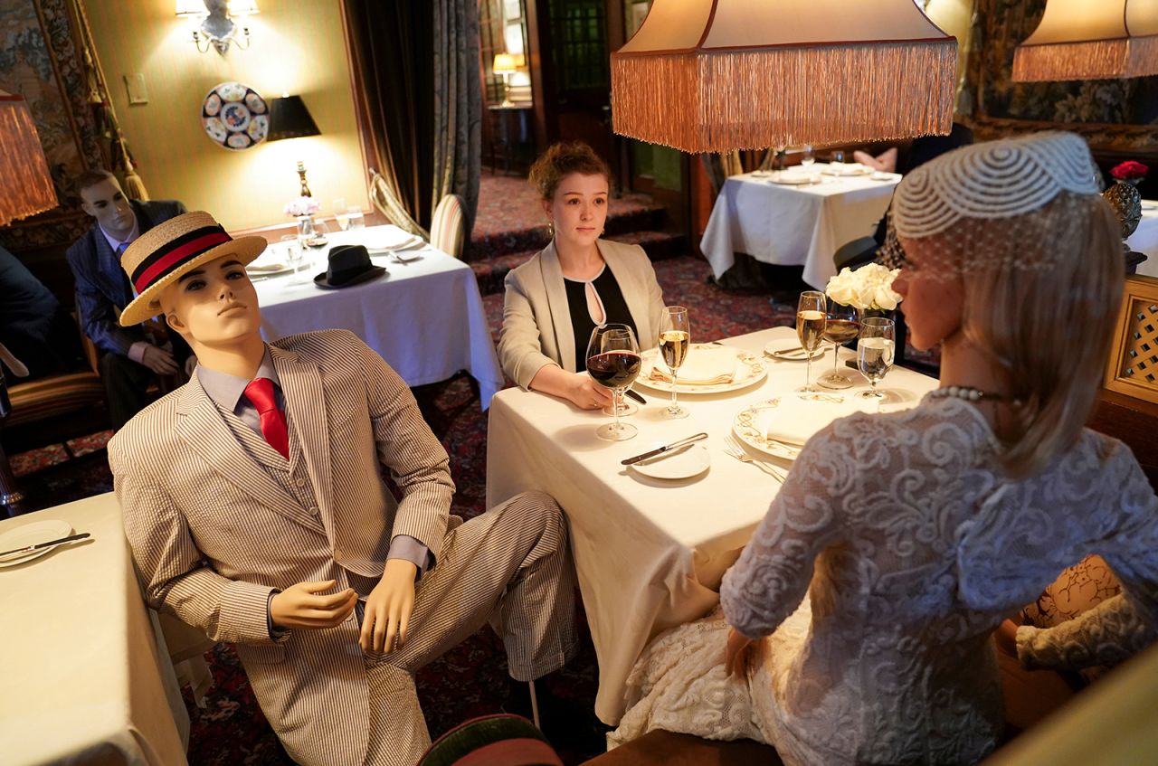 Jessie Dawson, an executive assistant for The Inn at Little Washington, is joined by mannequins as she sits in the Washington, Virginia, restaurant on Wednesday, May 20. The restaurant will be reopening later this month and kept at 50% capacity for social-distancing purposes. <a href="https://www.cnn.com/travel/article/restaurant-mannequins-coronavirus-inn-washington-trnd/index.html" target="_blank">Dressed-up mannequins will be seated among diners.</a>