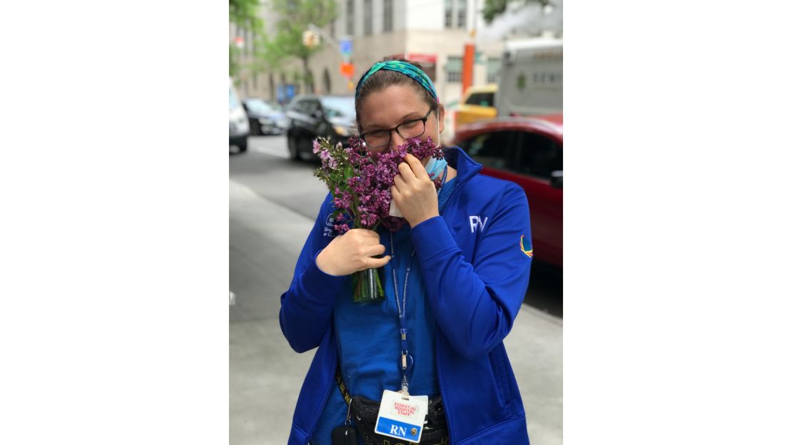 A nurse smelling the flowers she received from Miller and his team. 