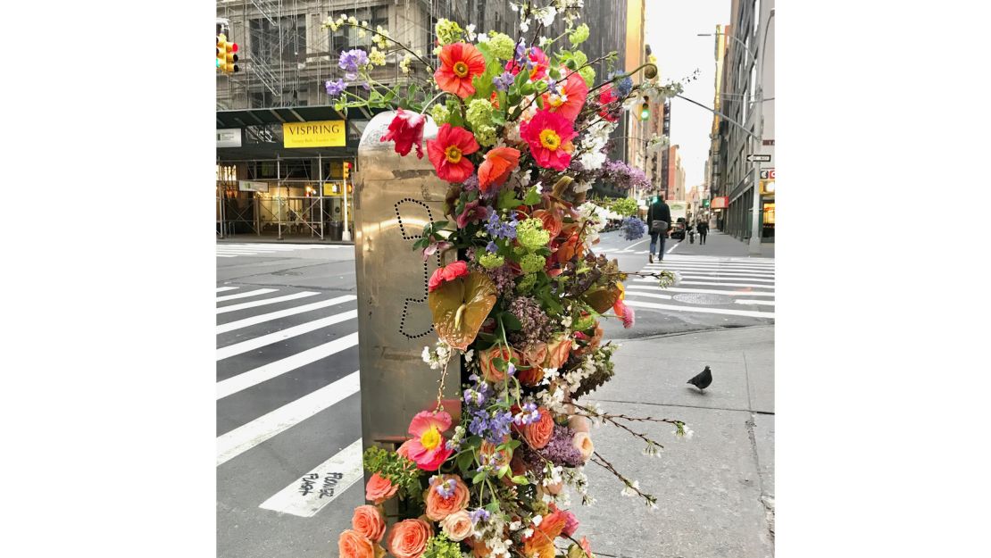 A New York phone booths erupting with flowers in one of Miller's flower flashes on March 12.  