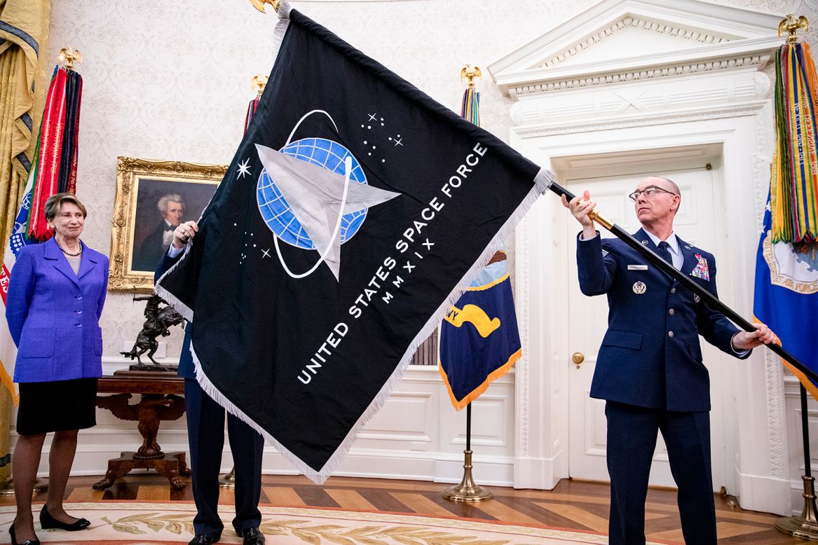 Chief Master Sgt. Roger Towberman, right, holds the official flag of the US Space Force as <a href="https://www.cnn.com/2020/05/16/politics/space-force-flag/index.html" target="_blank">it is unveiled in the White House Oval Office</a> on Friday, May 15. The Space Force is the newest branch of the US armed services. <strong><em>Correction:</em></strong><em> This photo caption has been updated to reflect that </em><em>Chief Master Sgt. Roger Towberman is</em> <em>the man holding the flag.</em>