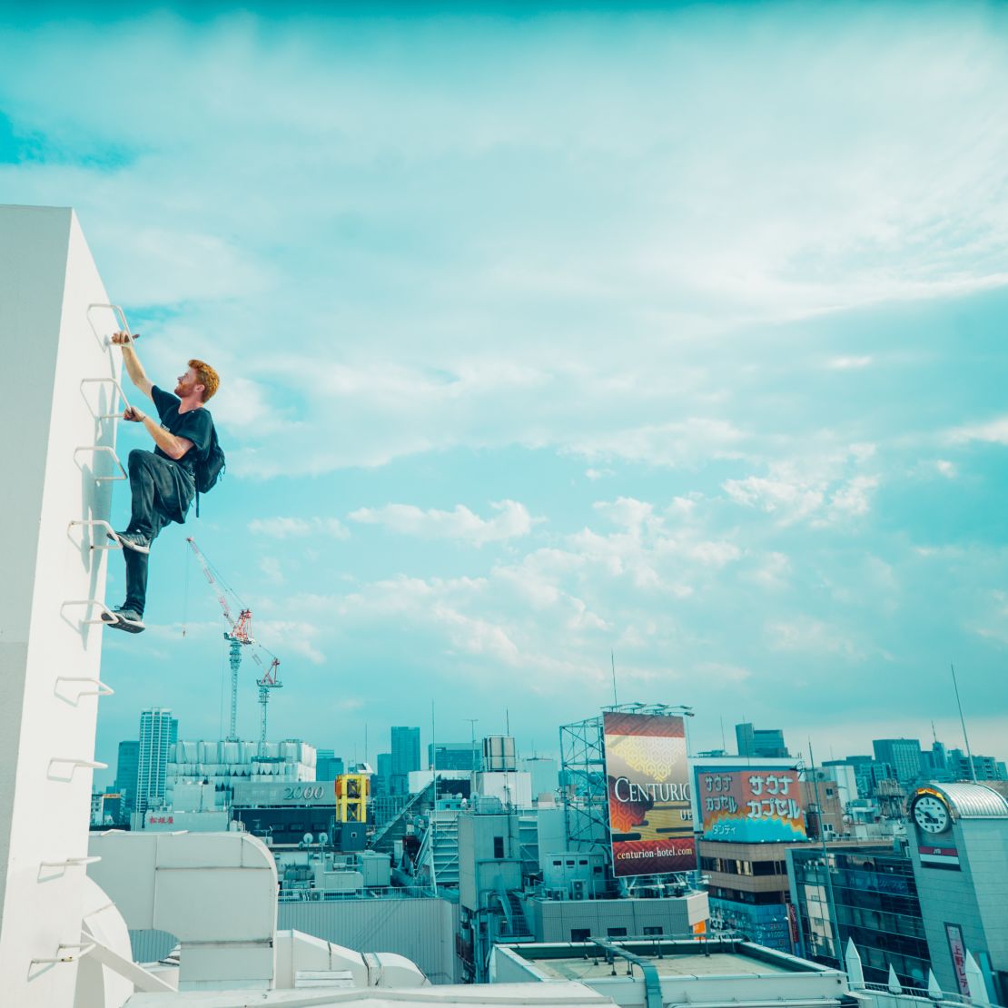 Segar climbs up the side of a building. 