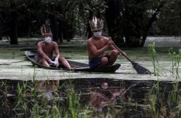 Satere-mawe indigenous men navigate the Ariau river during the COVID-19 novel coronavirus pandemic at the Sahu-Ape community, 80 km of Manaus, Amazonas State, Brazil, on May 5, 2020.